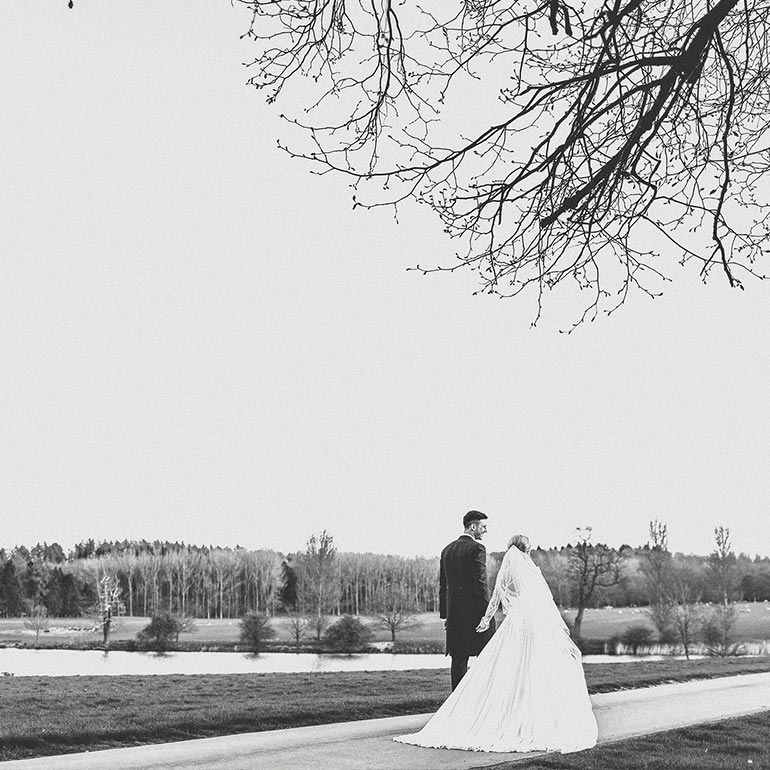 Bride and groom walking in the grounds at Ragley Hall